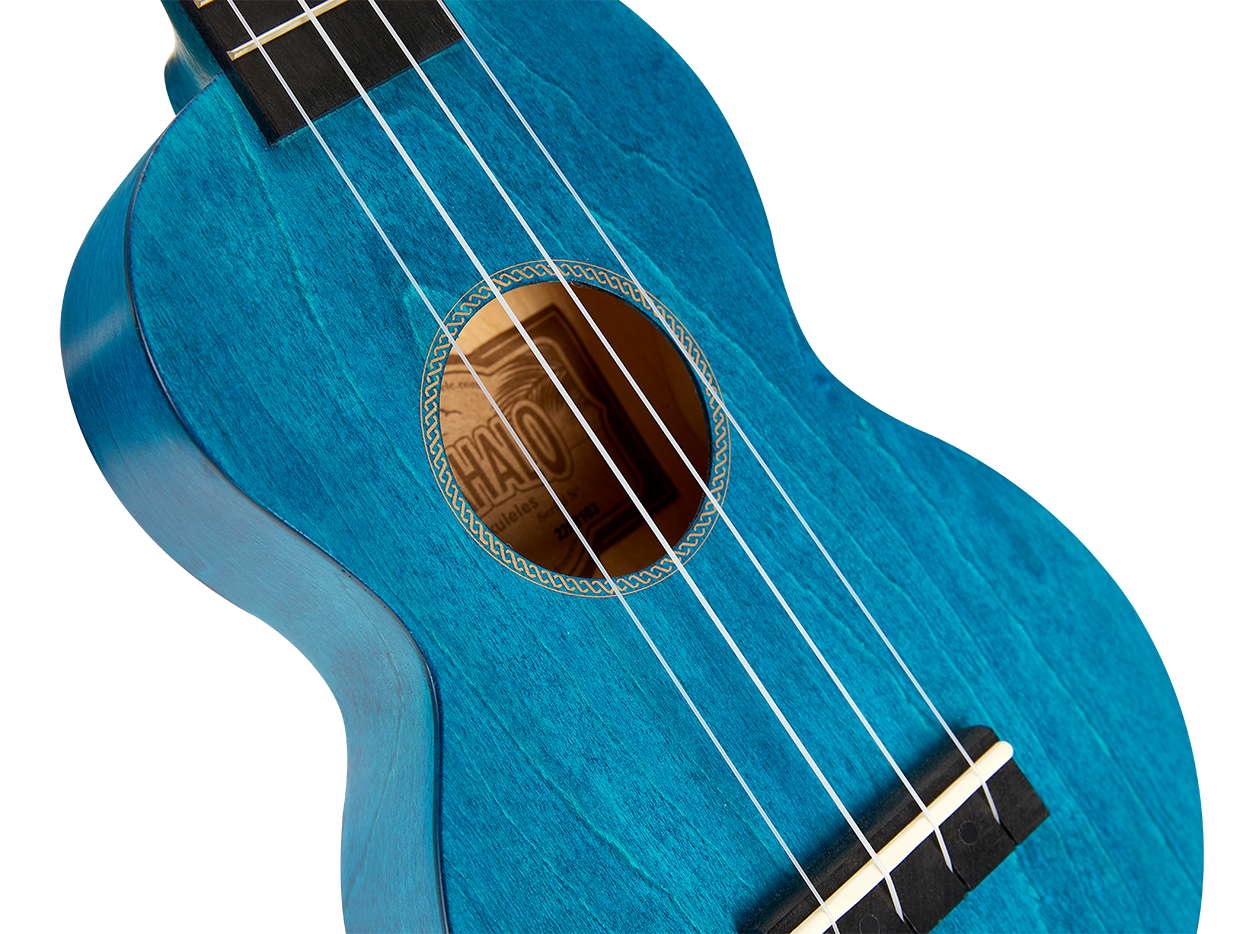Mahalo MS1TBU Slimline ukulele with transparent blue body, showing the sleek design and wood grain details.