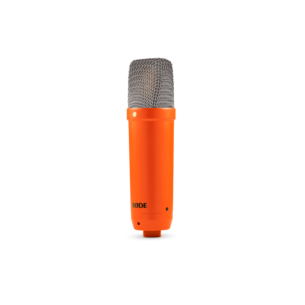 Rode NT1 Signature orange studio condenser microphone with black grille, studio setup, and microphone stand.