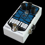 Pigtronix Quantum Time Modulator guitar effects pedal with knobs and inputs on a textured surface.