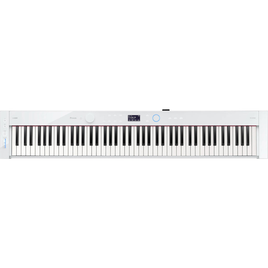 Casio Privia PX-S7000 portable digital piano in white with matching stand, compact design, and control panel visible.