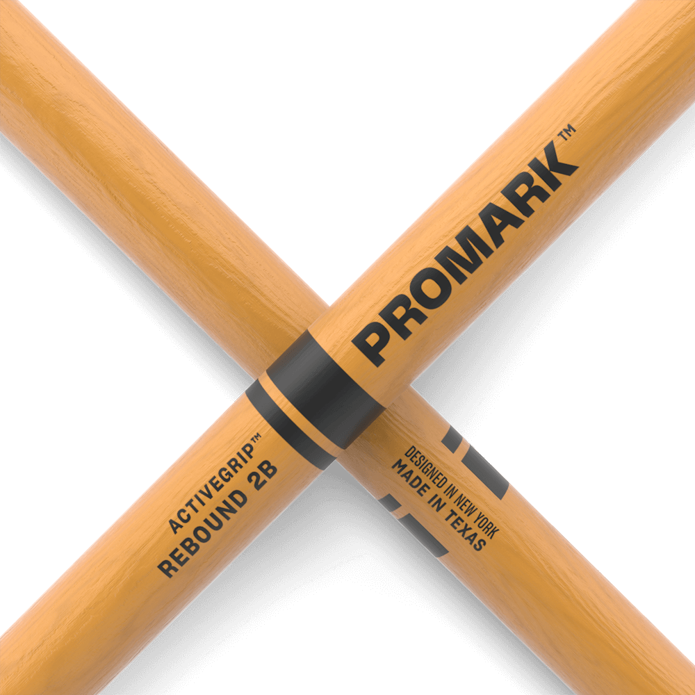 ProMark Rebound 2B ActiveGrip drumsticks with hickory wood and acorn tip, shown with clear finish and textured grip.