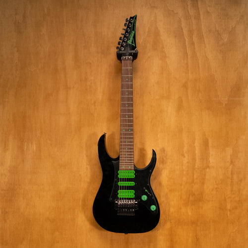 Ibanez UV70P Steve Vai 7-string electric guitar in black, showing the front view with sleek body and detailed fretboard.