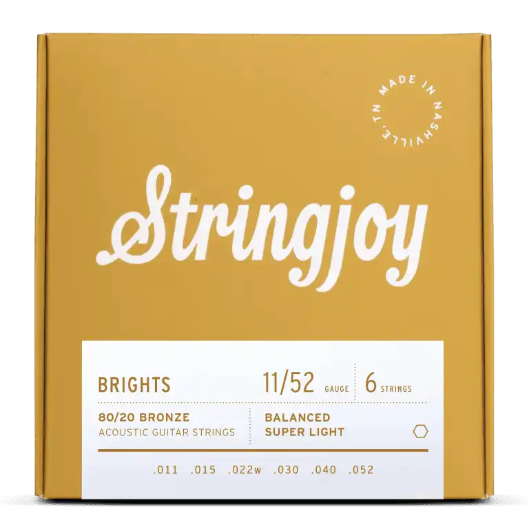 Stringjoy Brights Super Light Gauge 11-52 80/20 bronze acoustic guitar strings displayed on a guitar.