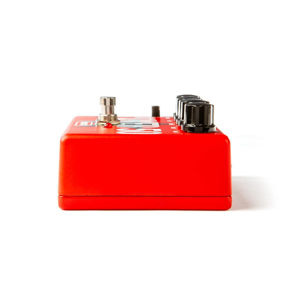 MXR TBM1 Tom Morello Power 50 overdrive effects pedal with control knobs and input/output jacks on a pedalboard.