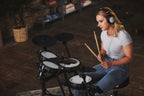 Roland TD-07DMK2 V-Drums electronic drum kit with mesh pads, cymbals, and drum module, set up on a stand for playing.