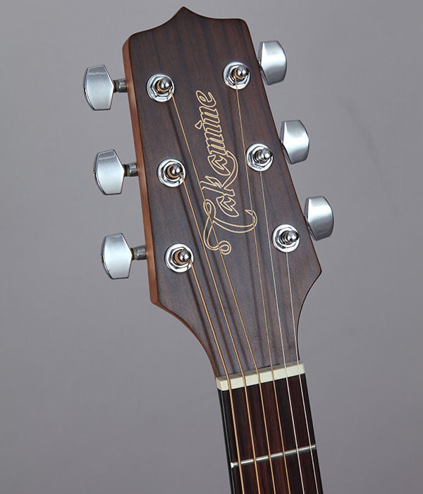Takamine G11 Series cutaway dreadnought acoustic guitar with pickup, made of mahogany, shown with a natural wood finish.