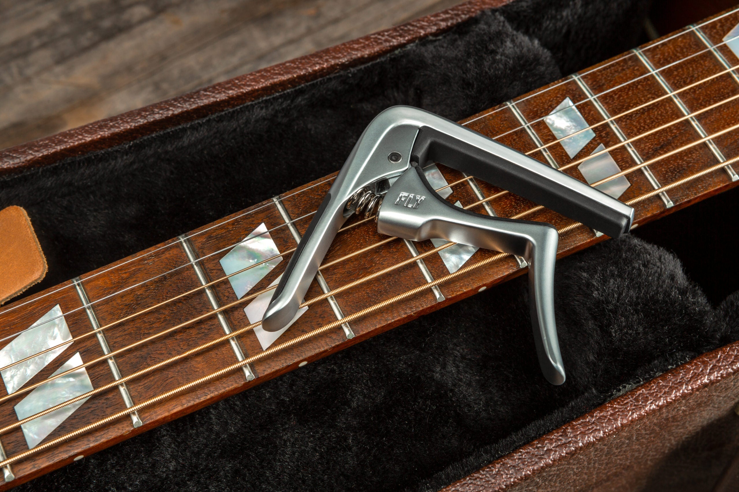 Jim Dunlop Trigger Fly Capo in satin chrome, a guitar capo with a sleek design and easy one-handed operation.