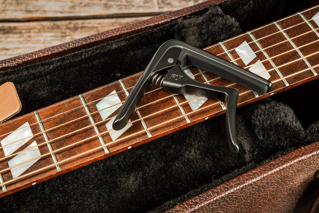Jim Dunlop Trigger Fly Capo in gunmetal, a guitar capo with a sleek design, metal construction, and quick-release trigger mechanism.