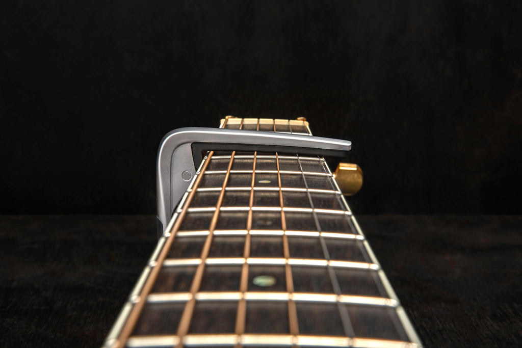 Jim Dunlop Trigger Fly Capo in satin chrome, a guitar capo for quick, secure string pressing and tone adjustment.