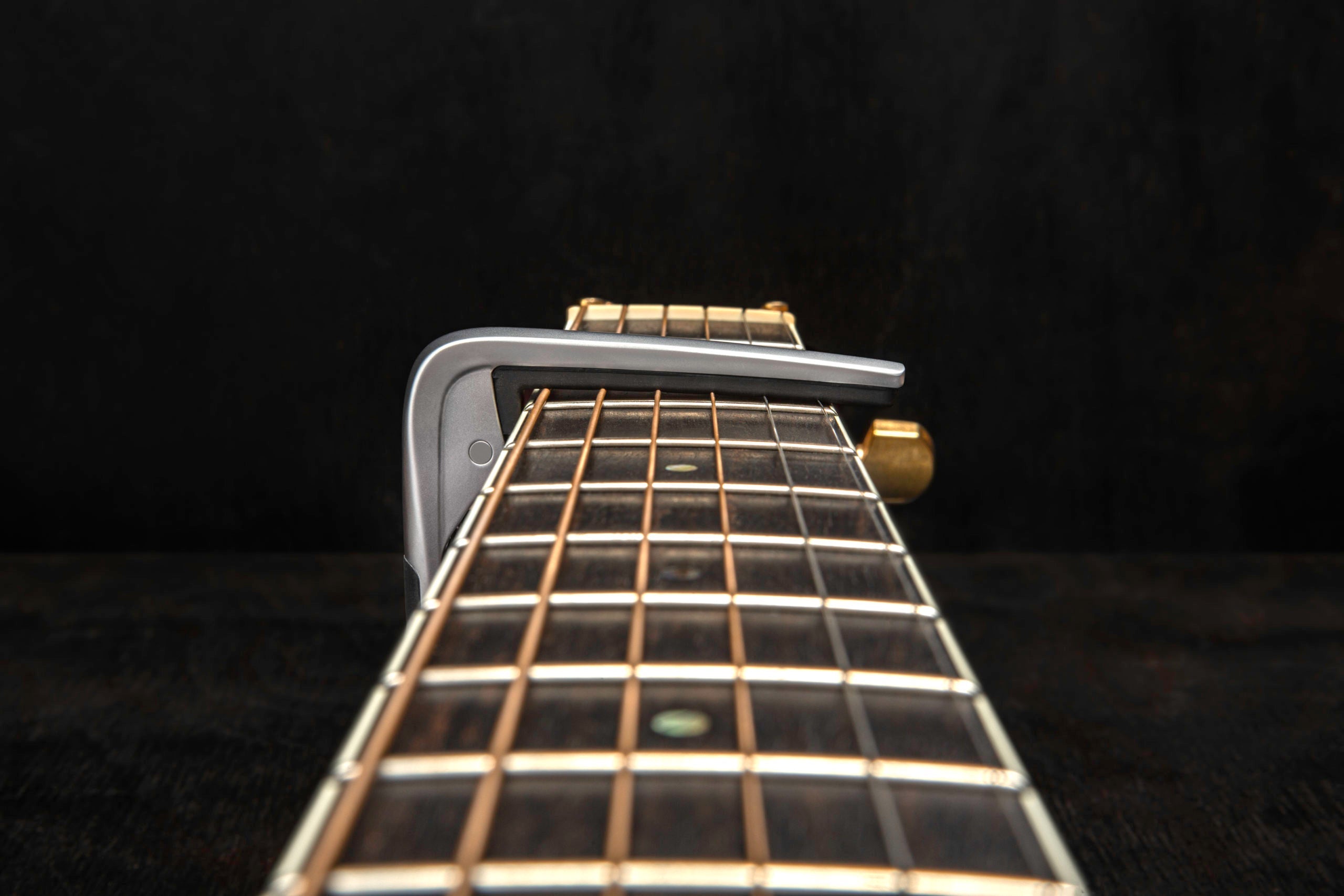 Jim Dunlop Trigger Fly Capo in satin chrome, a guitar capo for quick, secure string pressing and tone adjustment.