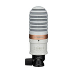 Yamaha YCM01B white studio condenser microphone on a stand in a recording studio setting.