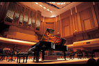 Yamaha CVP-909GP digital grand piano in polished ebony with matching bench, showcasing elegant design and keys.