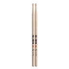 Vic Firth Charlie Watts Signature Series wood tip drumsticks on a drum set, showcasing their design and brand branding.