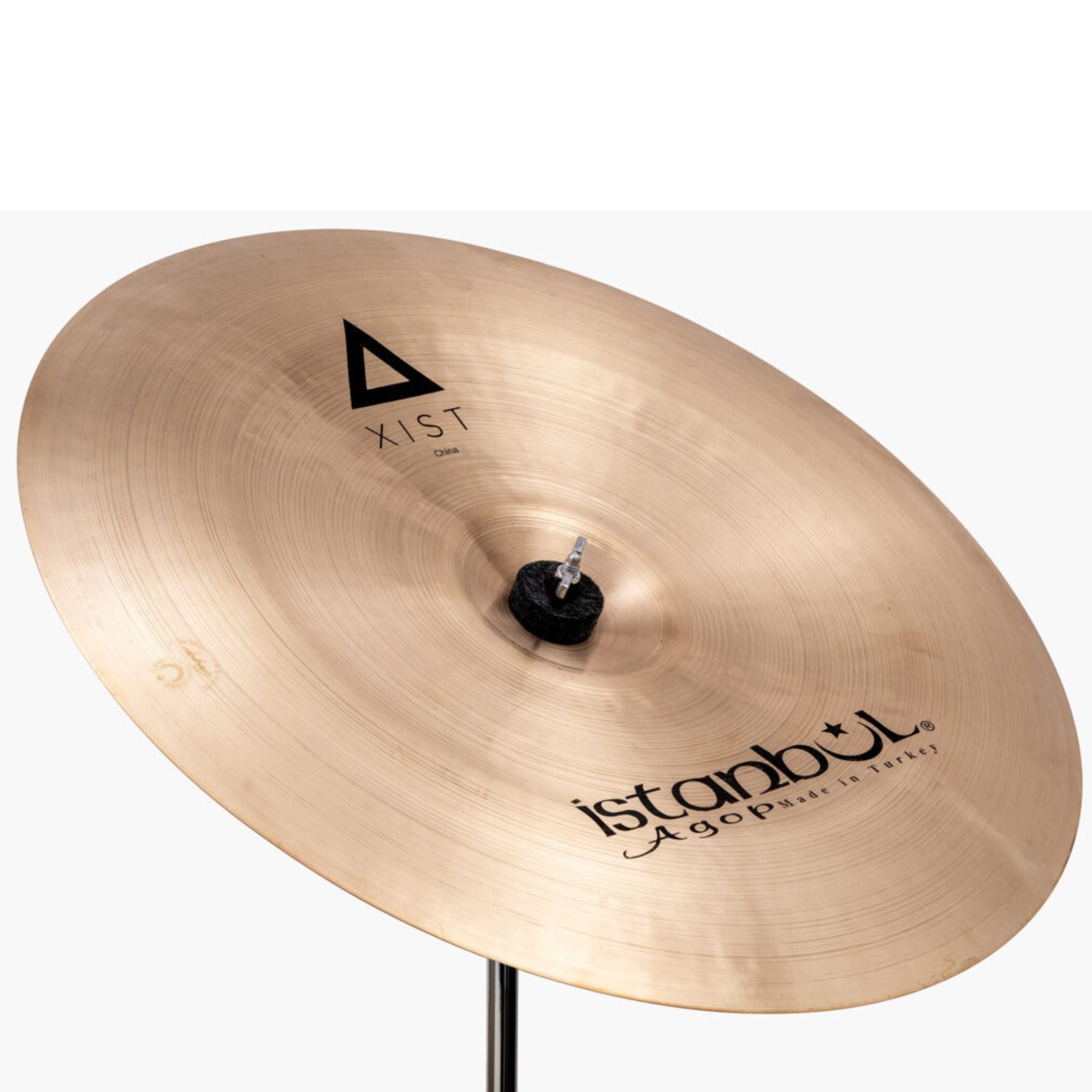 Istanbul Agop Xist China single cymbal with a shiny bronze finish, showcasing its large, curved shape and detailed branding.