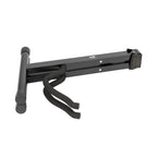 XTR X Frame guitar stand holding an acoustic guitar, showcasing sturdy guitar accessories for secure instrument support.