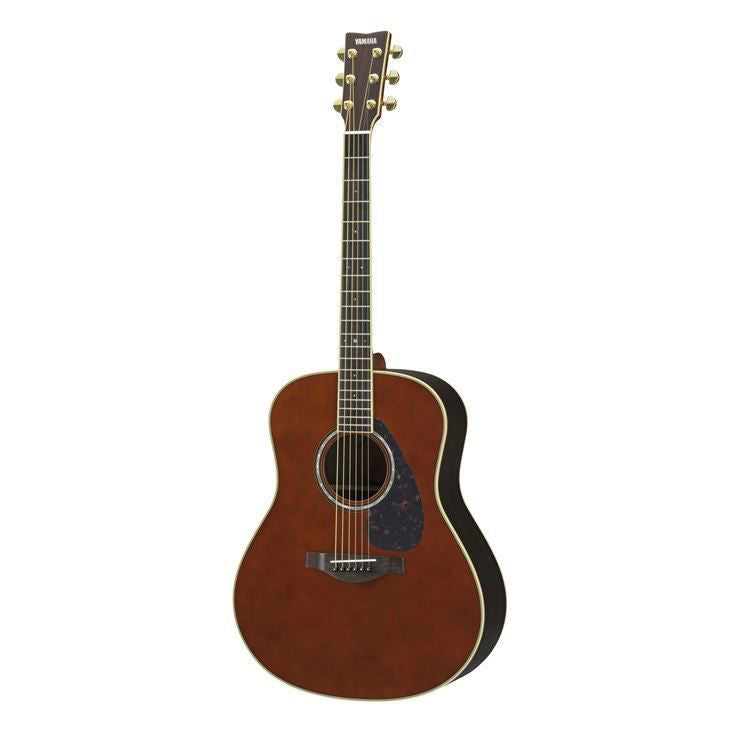 Yamaha LL6-DT//ARE acoustic guitar with dark tinted finish, showcasing a wooden body and steel strings in a natural setting.
