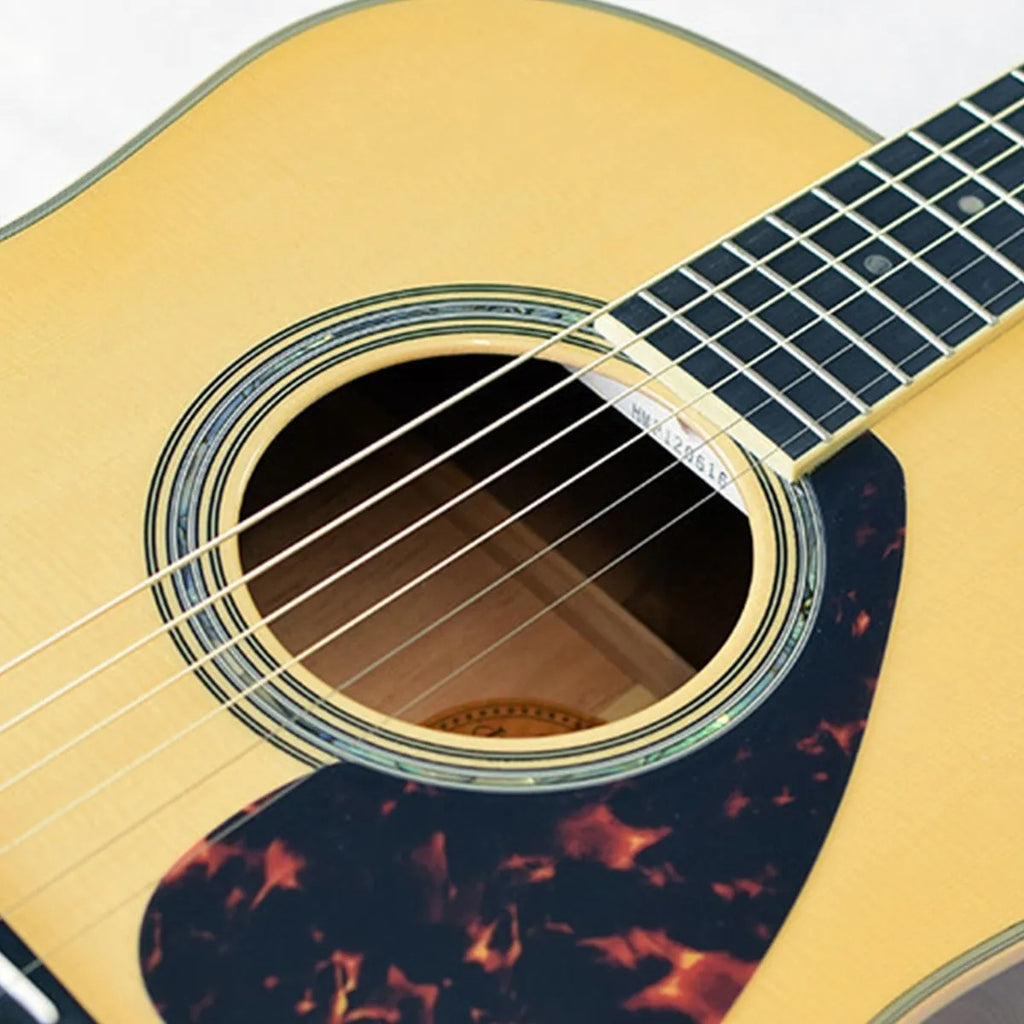 Yamaha LL16M-NT/ARE acoustic guitar in natural finish, featuring a solid wood top and cutaway body design.