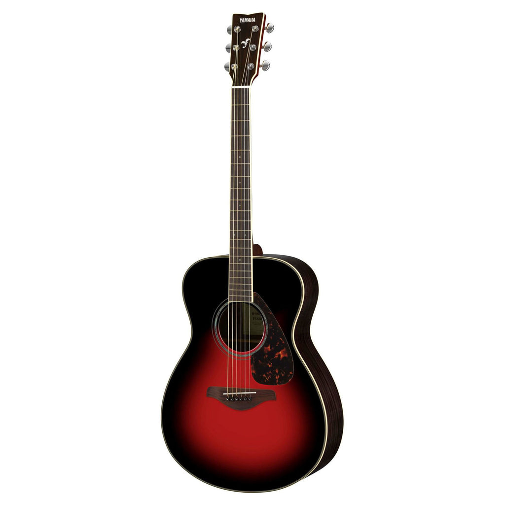 Yamaha FS830DSR acoustic guitar with a dusky sun red finish, showing the body, fretboard, and soundhole in a natural setting.