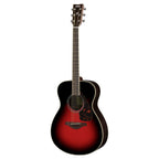Yamaha FS830DSR acoustic guitar with a dusky sun red finish, showing the body, fretboard, and soundhole in a natural setting.