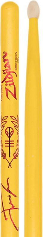 Zildjian Artist Series Josh Dun drumsticks with yellow Clancy handles resting on a drum kit.