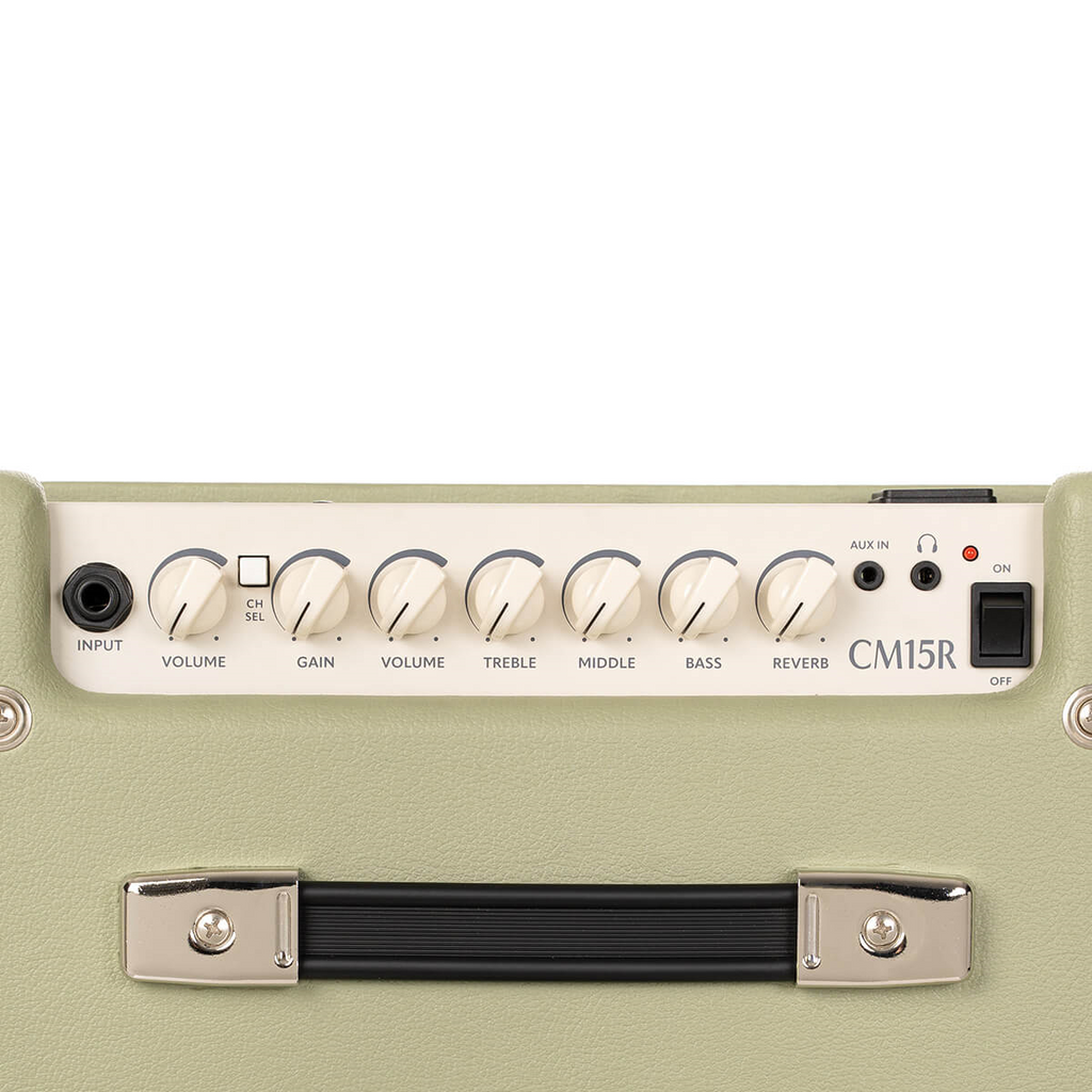 Cort CM15R PG 15W guitar combo amplifier in pastel green with control knobs and speaker grille, designed for electric guitar sound.